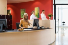 RECEPTIONIST WITH PASSING PEOPLE